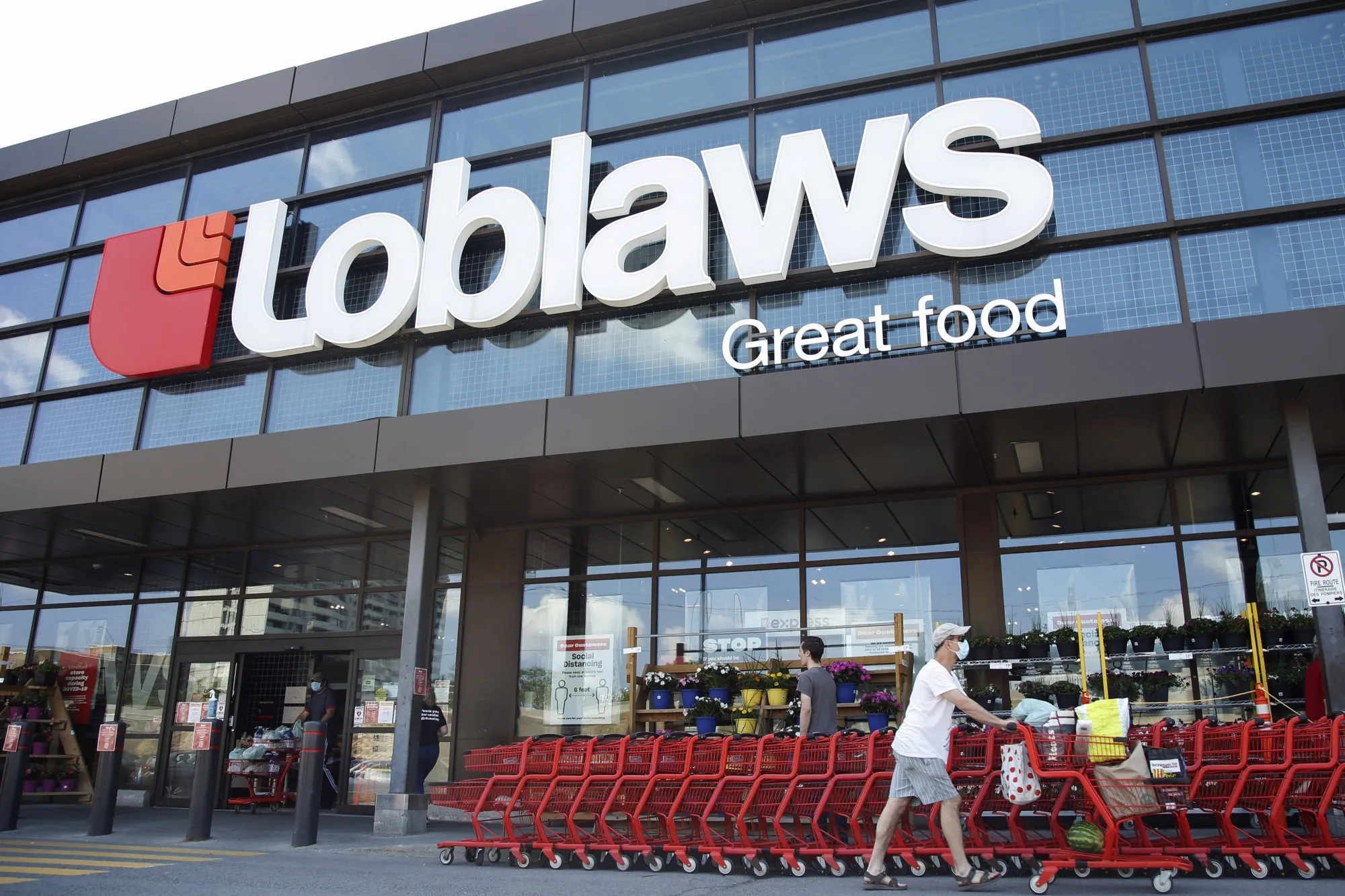 A customer exits a Loblaws store in Ottawa, Ontario, in July.