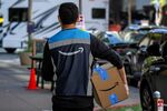 An Amazon worker delivers a package in San Francisco, California. Photographer: David Paul Morris/Bloomberg