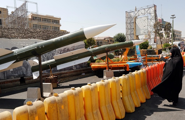 A&nbsp;woman looks at Taer-2 missiles during a street exhibition by Iran's army and paramilitary Revolutionary Guard&nbsp; in Tehran on Sept. 26, 2019.&nbsp;Photo by stringer/AFP via Getty Images.