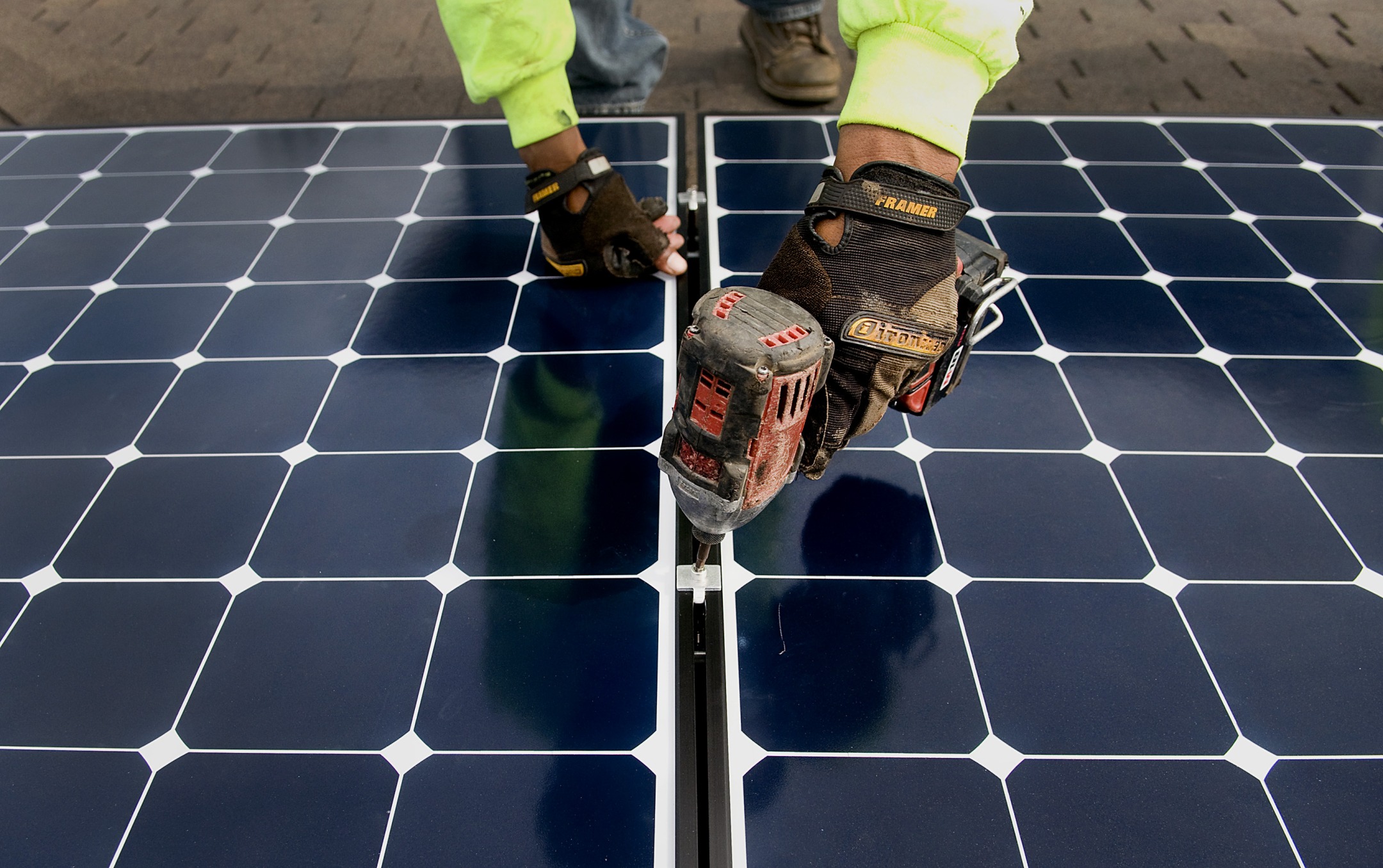 An installer secures a solar panel during installation at a home in Encinitas, California.
