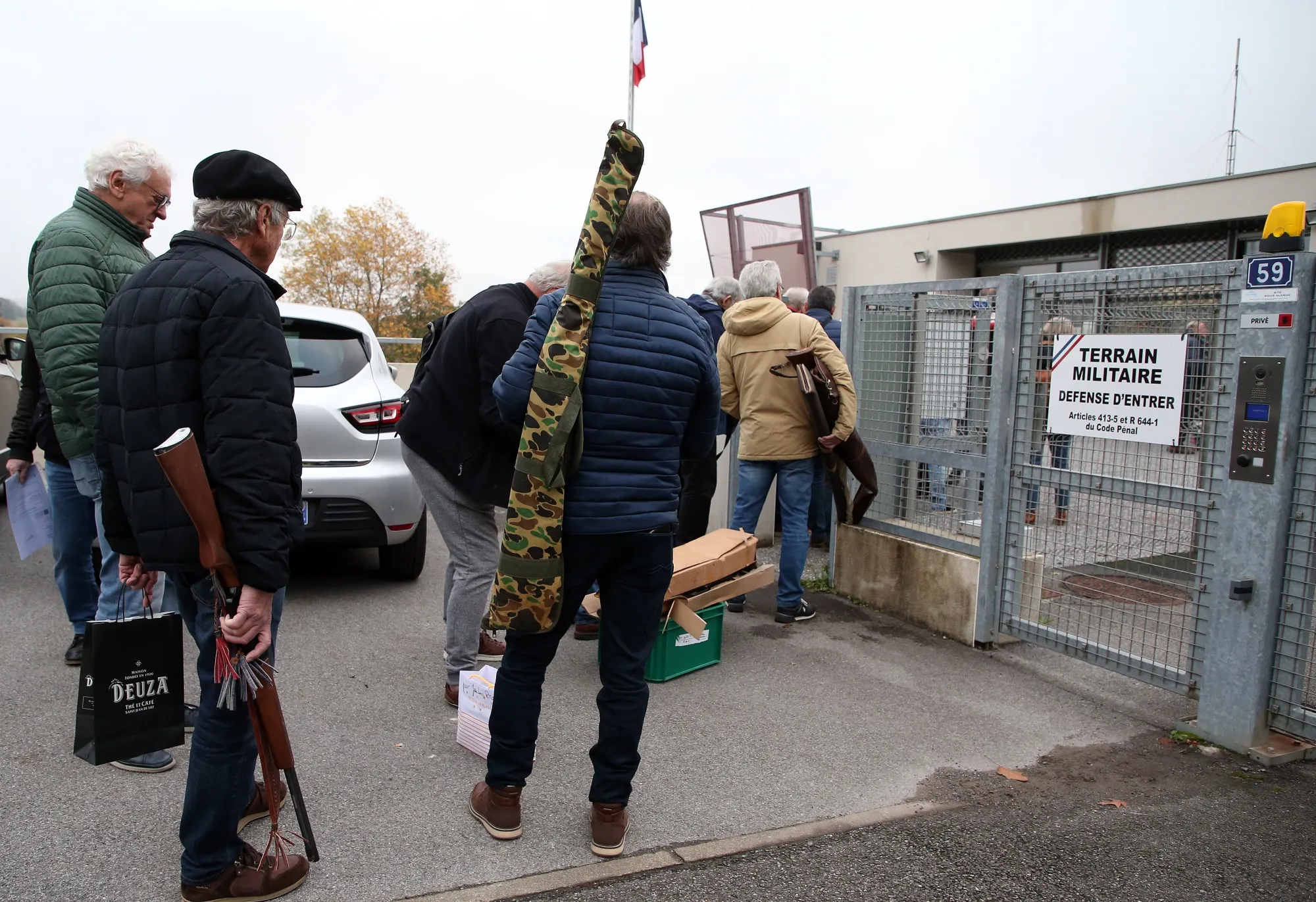 People wait to bring back their weapons to the Ustaritz gendarmerie, southwestern France, Thursday, Dec.1, 2022. France has launched a nationwide push to collect millions of old firearms; remnants of the two World Wars or long-abandoned hunting habits. (AP Photo/Bob Edme)