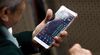 An investor looks at stock price movements on a smartphone phone at a securities company in Beijing on October 12, 2018. - Asia's main stock markets traded lower, but losses were relatively muted as investors took a breather after a global rout sparked by fears over higher US interest rates. (Photo by Nicolas ASFOURI / AFP) (Photo credit should read NICOLAS ASFOURI/AFP/Getty Images)