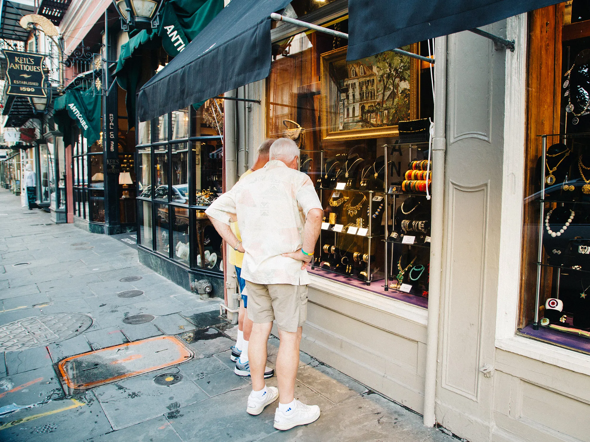 Pedestrians stop to view a window display at a jewelry store in the French Quarter district of New Orleans, Louisiana.