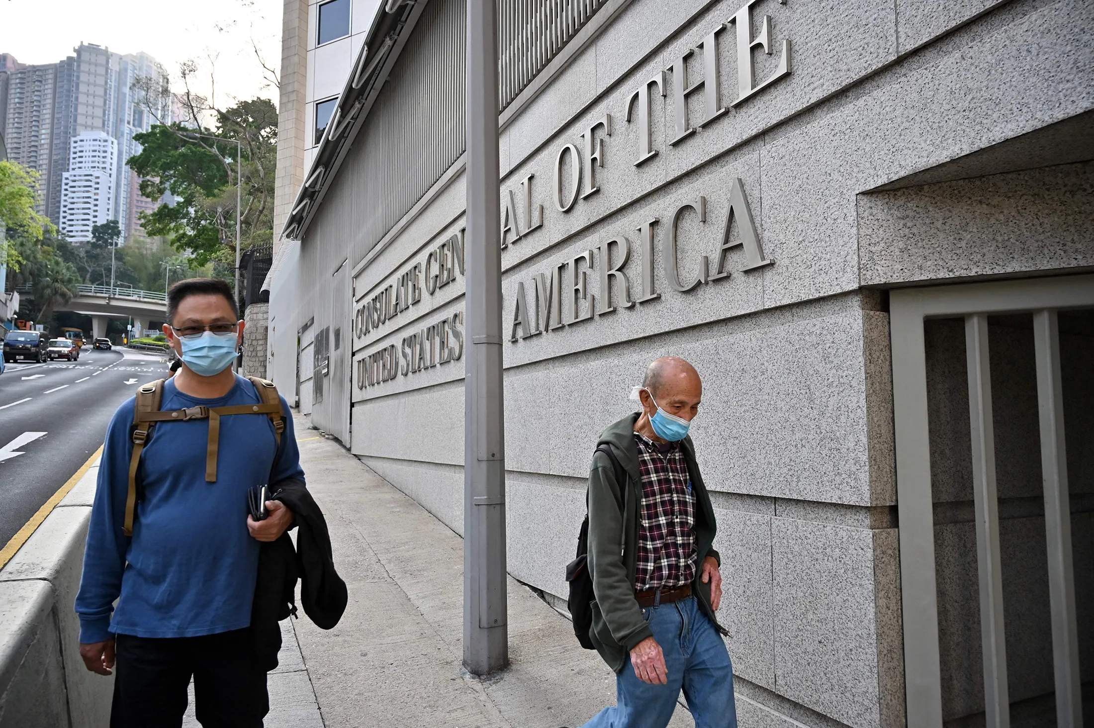 People walk past the U.S. consulate building in Hong Kong.