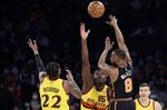 New York Knicks guard Kemba Walker (8) passes over Atlanta Hawks center Clint Capela (15) during the first half of an NBA basketball game Saturday, Dec. 25, 2021, in New York. (AP Photo/Adam Hunger)