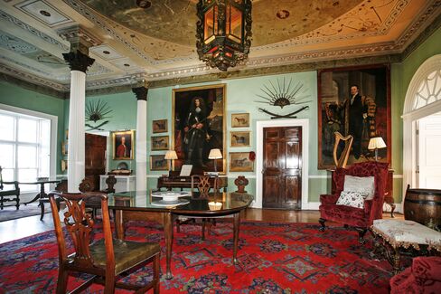 The front hall with its screen of Corinthian columns, a neoclassical ceiling, and historic portraits of the Knights of Glin. The romantic title dates back to the early 13th century.
