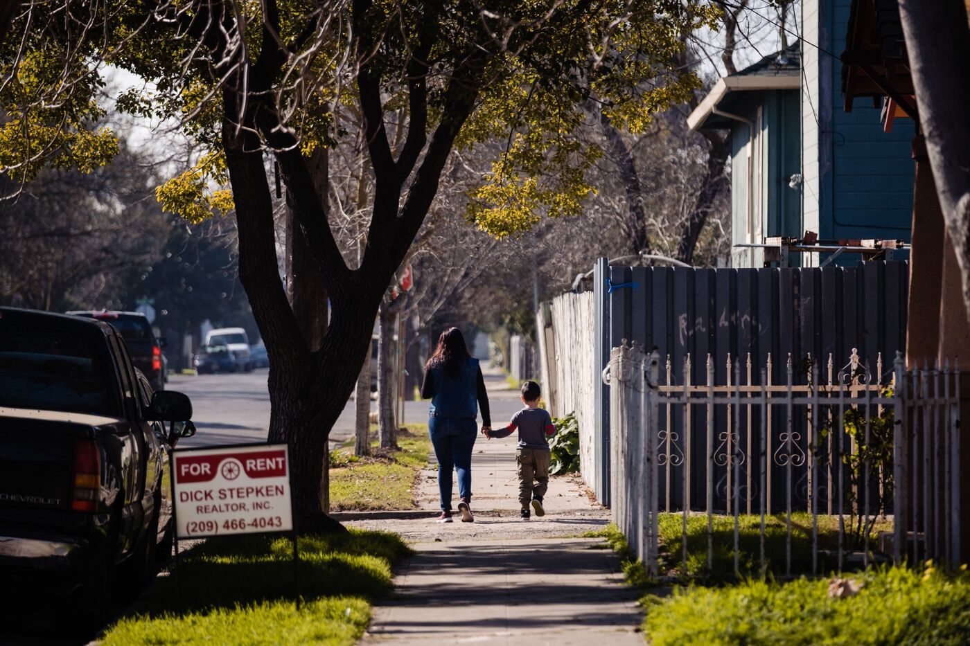 A mother and son walk through one of the neighborhoods of Stockton, California, in 2020, where&nbsp;residents participated in an two-year&nbsp;trial of universal basic income. Officials are now starting such programs at the county level.&nbsp;