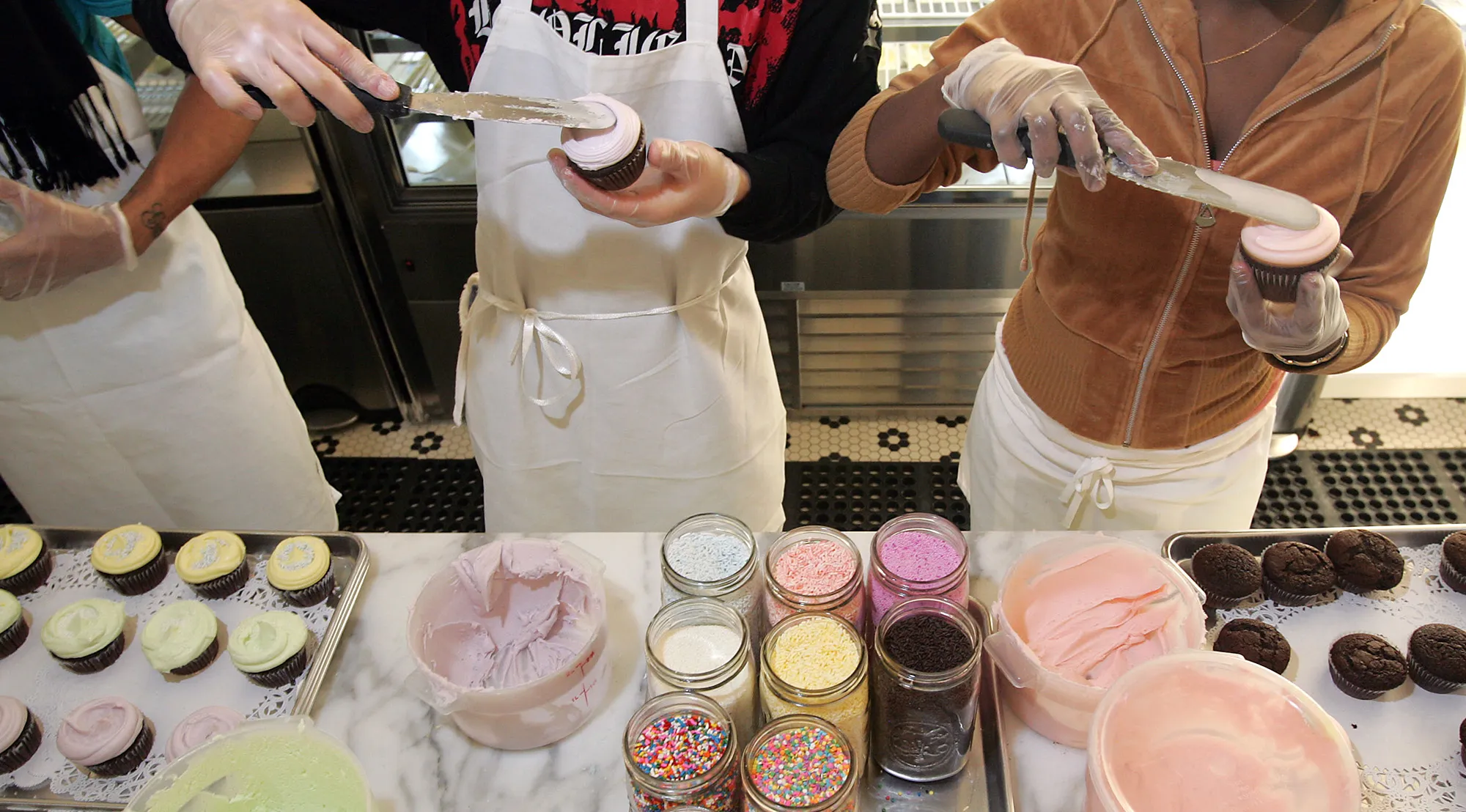 Cupcakes are frosted at a bakery in New York.