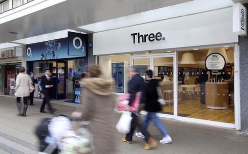 An O2 mobile phone store next to a Three store in Basildon, U.K.
