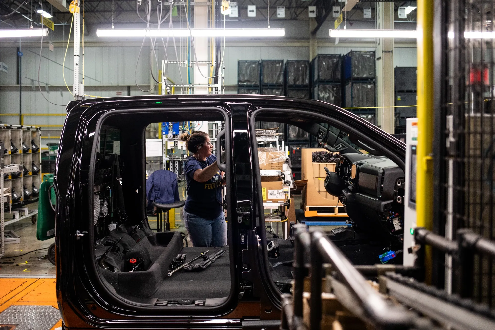 A worker assembles the interior of a vehicle at the General Motors assembly plant in Fort Wayne, Indiana, in 2024.