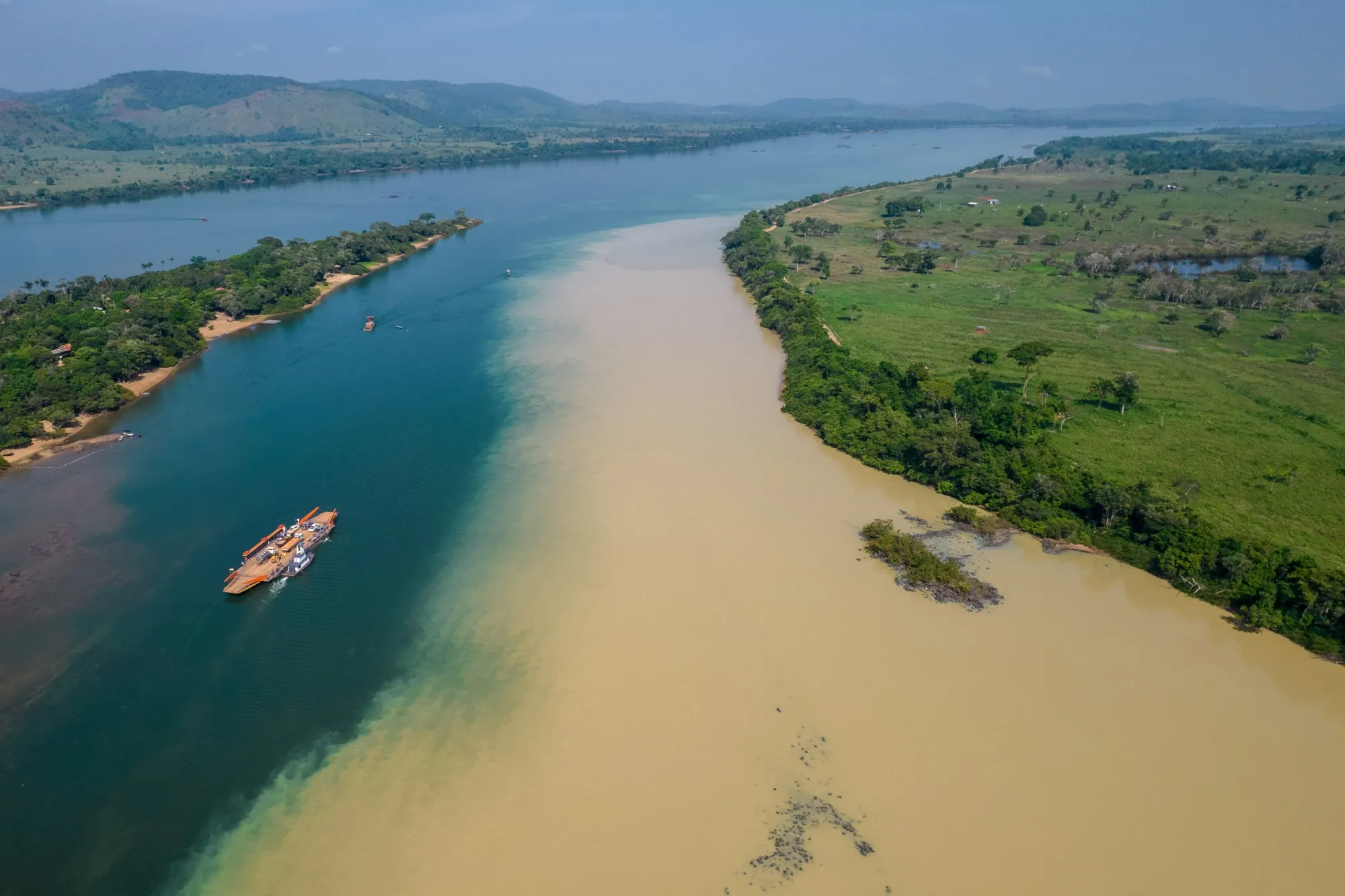 A boat passes through the meeting of the Xingu River and the Rio Fresco in Sao Felix do Xingu, Para state, Brazil, on Tuesday, Oct. 5, 2021. Destruction of the Brazilian Amazon accelerated this year to levels unseen since 2006, with more than 5,019 square miles of forest lost between August 2020 and July 2021. Photographer: Jonne Roriz/Bloomberg
