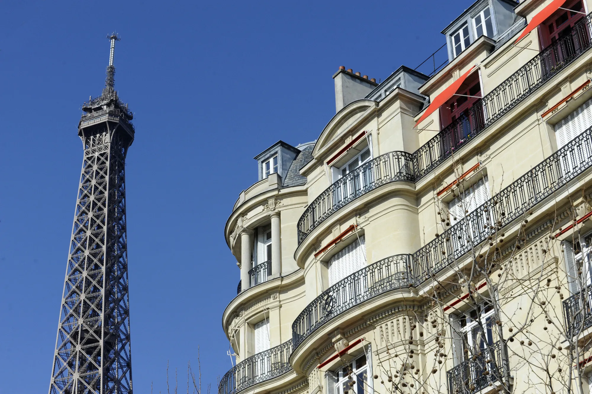 The Eiffel Tower stands near apartments in the 8th arrondissement district of Paris, France, on Monday, March 7, 2011. Paris property prices have risen more than in the rest of France, mirroring how London real estate has diverged from the rest of the U.K.
