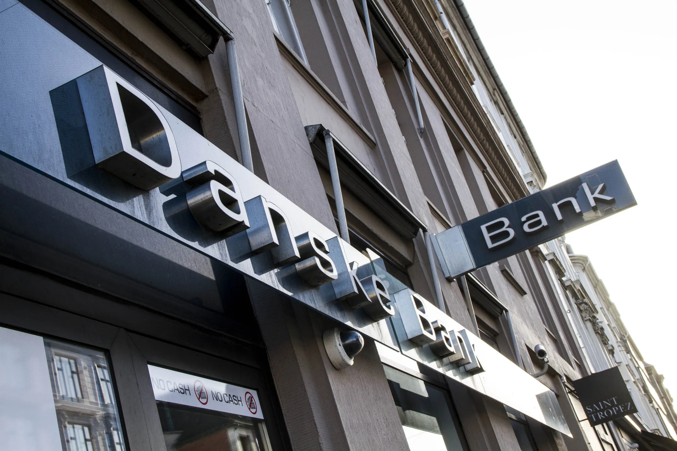 A logo sits above the entrance to a Danske Bank A/S branch in Copenhagen, Denmark, on Tuesday, Nov. 12, 2013.