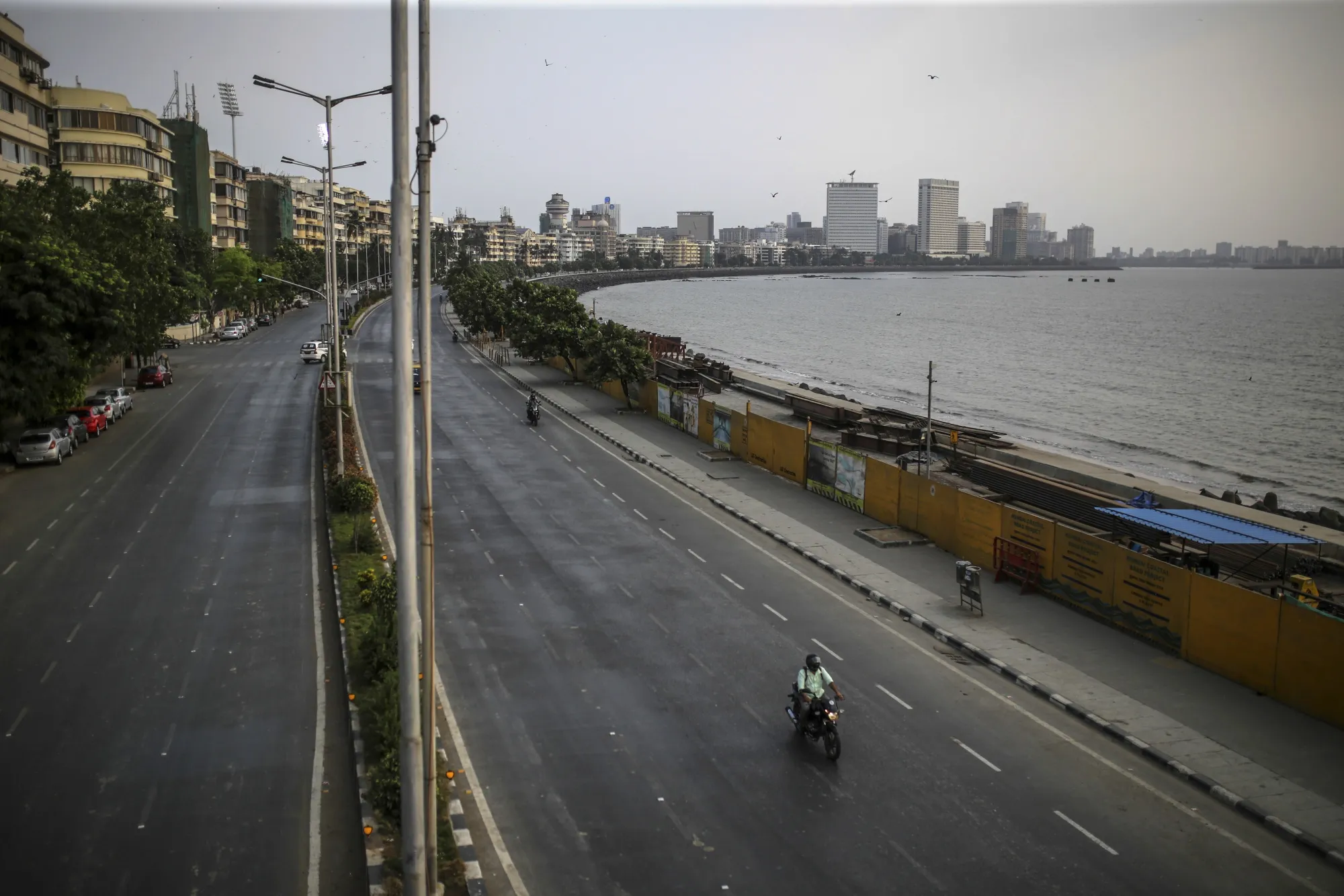 A motorcyclist travels along a deserted Marine Drive during a weekend lockdown in Mumbai, on April 10.
