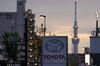 Toyota Motor Co. signage is displayed outside a dealership as the Tokyo Sky Tree stands in the background at night in Tokyo, Japan, on Sunday, May 10, 2020.