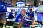 Traders work on the floor of the New York Stock Exchange (NYSE) in New York, U.S., on Tuesday, March 15, 2022. 