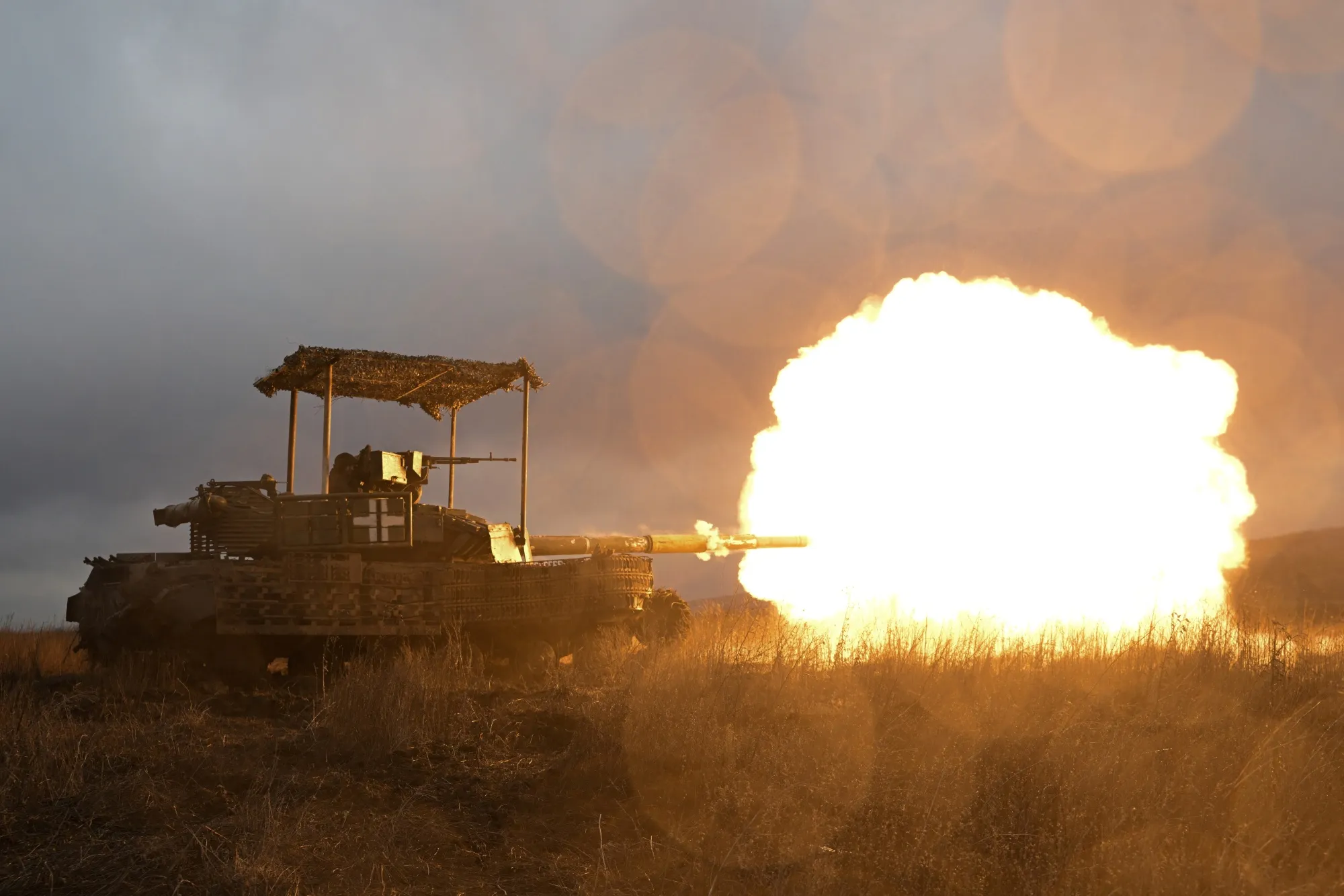 Ukrainian servicemen fire with a tank in the Donetsk region on Feb. 5.