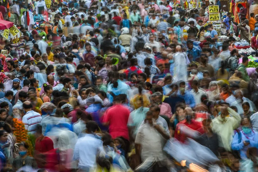 Shoppers crowd a flower market on the eve of the Maharashtrian new year in Mumbai on April 1, 2022.