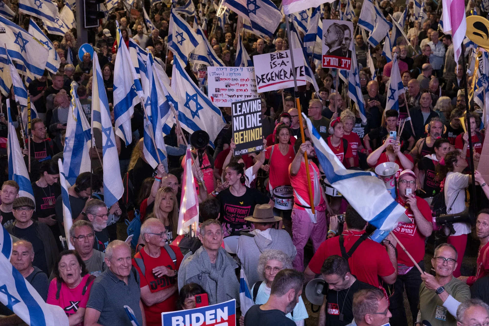 Protesters hold flags and signs during a demonstration calling for an hostages deal with Hamas and against Israeli Prime Minister Benjamin Netanyahu and his government on April 20&nbsp;in Tel Aviv.