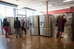 Customers view refrigerators displayed for sale at the Airport Home Appliance store in San Jose, California, U.S., on Tuesday, July 30, 2019.