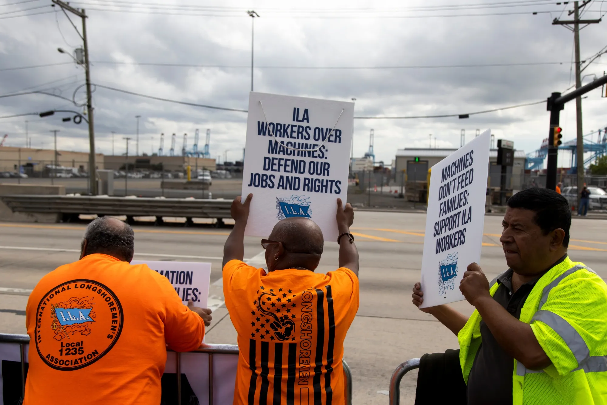 Workers picket outside of the APM container terminal at the Port of Newark in Newark, New Jersey, on Oct. 1.