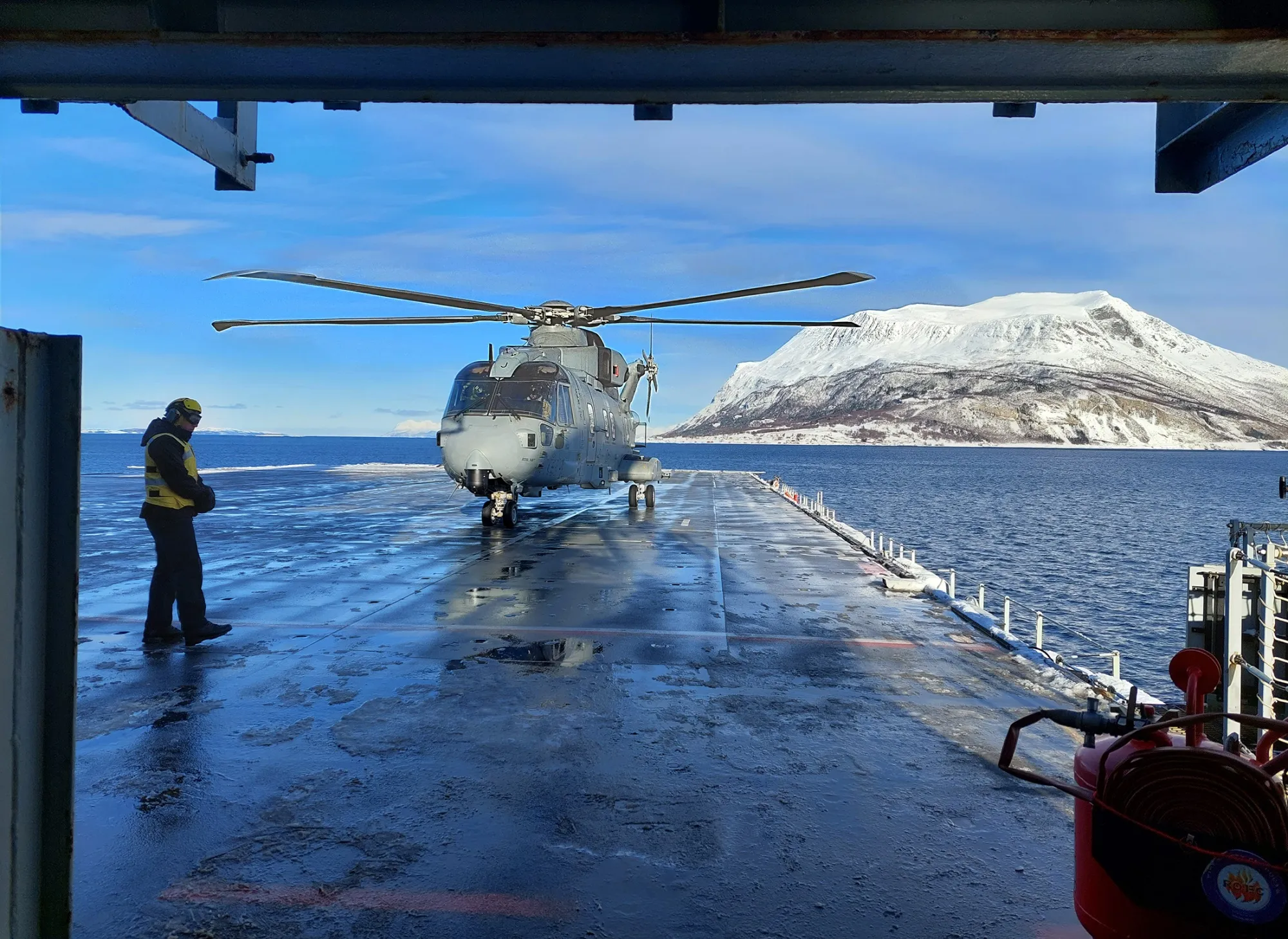 A Merlin helicopter lands on the deck of the UK Navy's HMS Albion on March 7&nbsp;in Vagsfjord, southeast of Harstad, Norway.