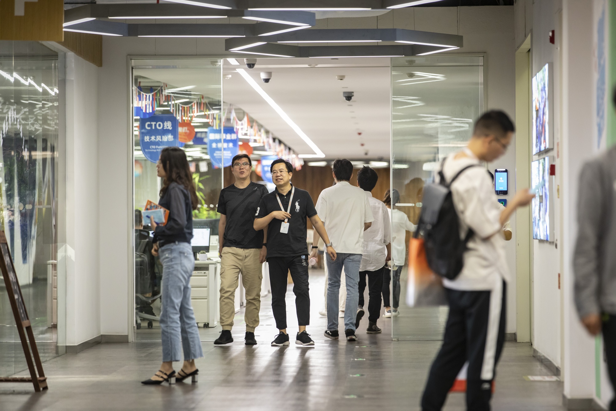 Employees walk past the Ant Group Co. headquarters in Hangzhou, China, Monday, Sept. 28, 2020. 