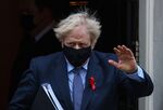 Boris Johnson waves as he departs from number 10 Downing Street on his way to Parliament in London, on Dec. 1. 