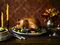 Roast turkey with garnish and platter on rustic wooden table