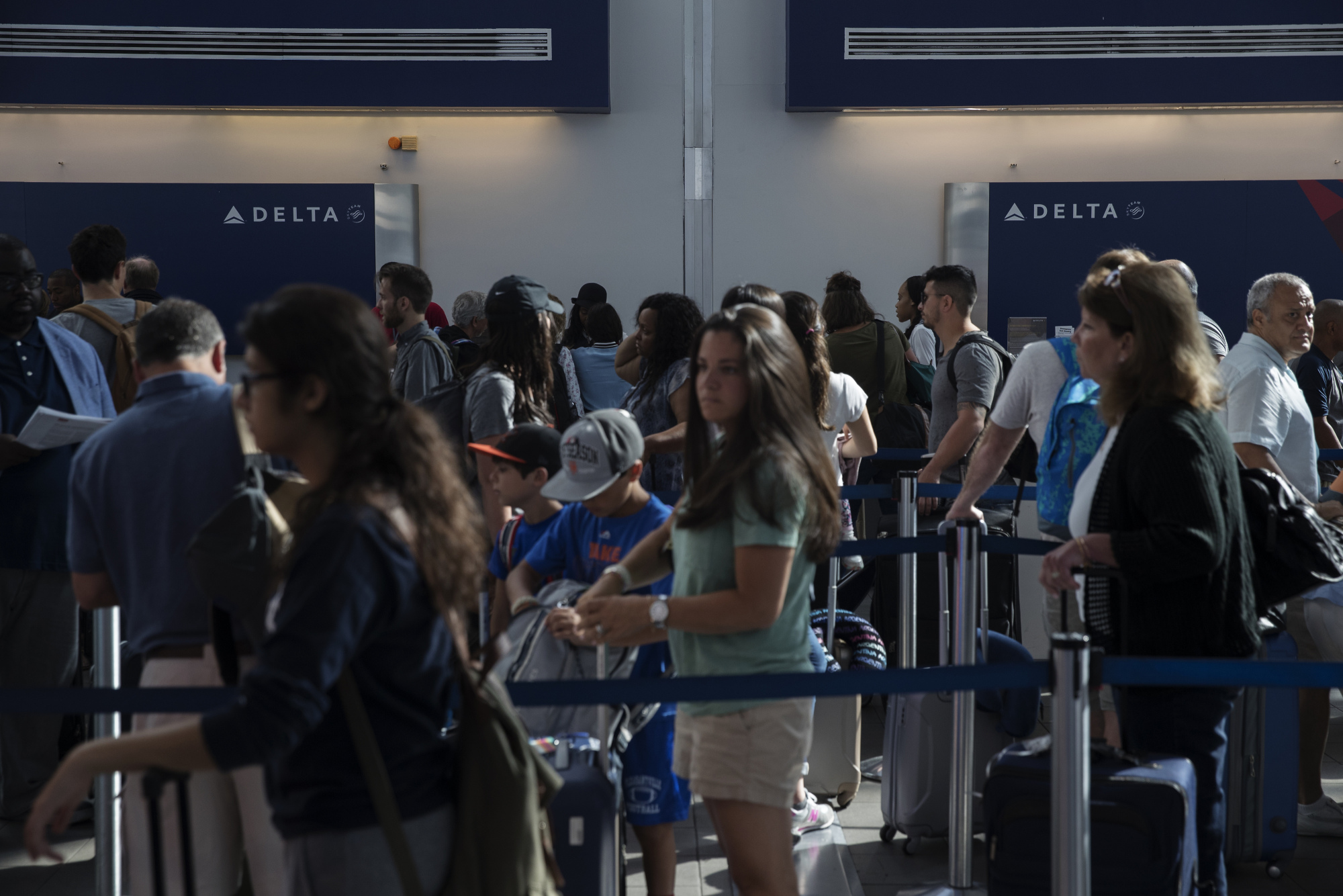Delta passengers wait at LaGuardia Airport on Aug. 8. Photographer: Victor J. Blue/Bloomberg
