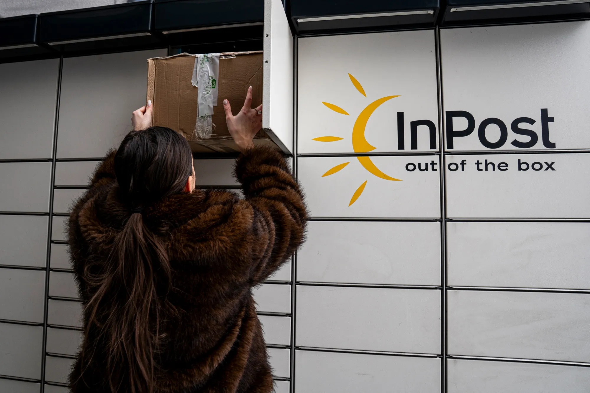 A customer uses an InPost parcel locker&nbsp;in Warsaw.