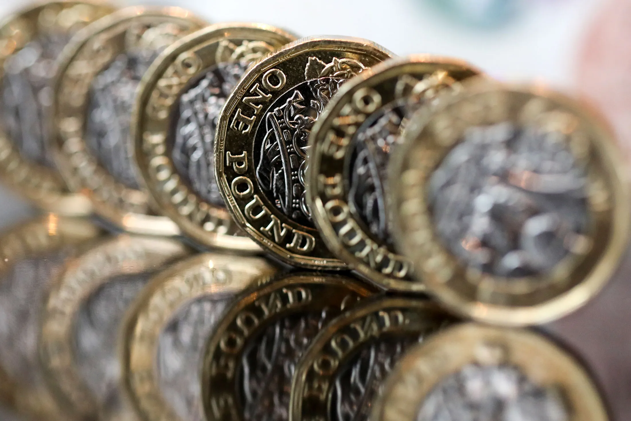A row of one pound sterling coins stand in this arranged photograph in London, U.K., on Tuesday, Sept. 19, 2017. Strategists are revising their estimates for the currency after its best week since 2009 saw it gain almost 3 percent as the Bank of England signaled it would look to withdraw stimulus “over the coming months.” Photographer: Chris Ratcliffe/Bloomberg
