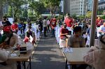 People queue for a free rapid test for the Covid-19 coronavirus, in Jakarta on June 21.