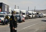 A police officer stands guard at the Panamerican Highway blocked by truck drivers demanding nationwide lower fuel costs and reduced toll payments, near the southern Andean city of Arequipa, Peru on March 28.