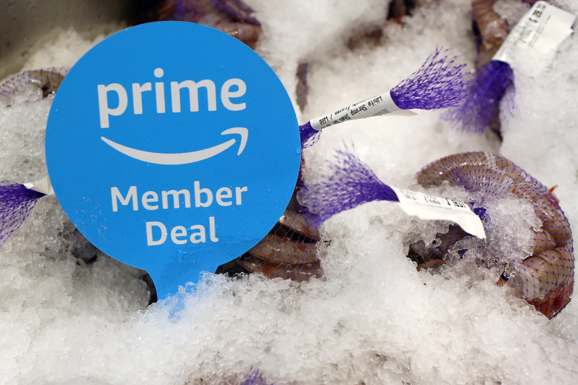 A sign alerts Amazon.com Inc. Prime members of a special deal on shrimp a Whole Foods Market Inc. location in Burbank, California, U.S., on Wednesday, June 20, 2018. Customer traffic was up 2.4 percent at Whole Foods stores during the first five months of 2018, a sign that Amazon has managed to draw in new shoppers with ballyhooed price cuts on a handful of items.