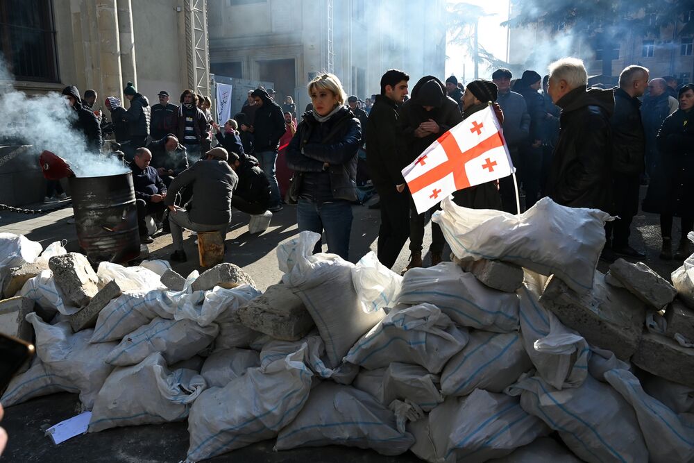 Anti-government protesters block an area near the entrance to parliament in Tbilisi on Nov. 18.