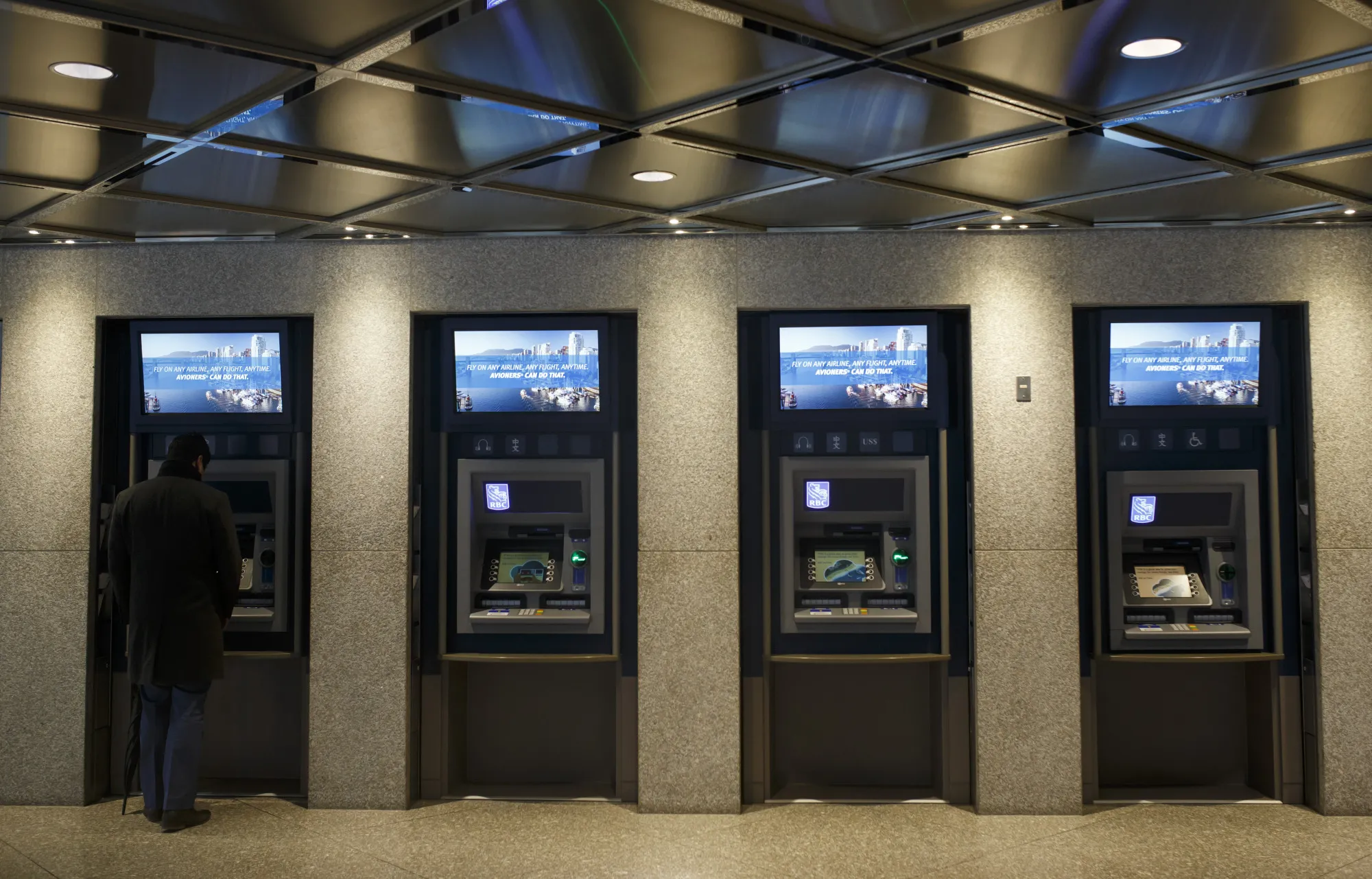 A customer uses an automated teller machine (ATM) at a Royal Bank of Canada (RBC) branch during the company's annual general meeting in Toronto, Ontario, Canada, on Thursday, April 6, 2017. RBC Chief Executive Officer David urged lawmakers to coordinate interventions and act quickly to cool housing markets, particularly in Toronto and Vancouver.