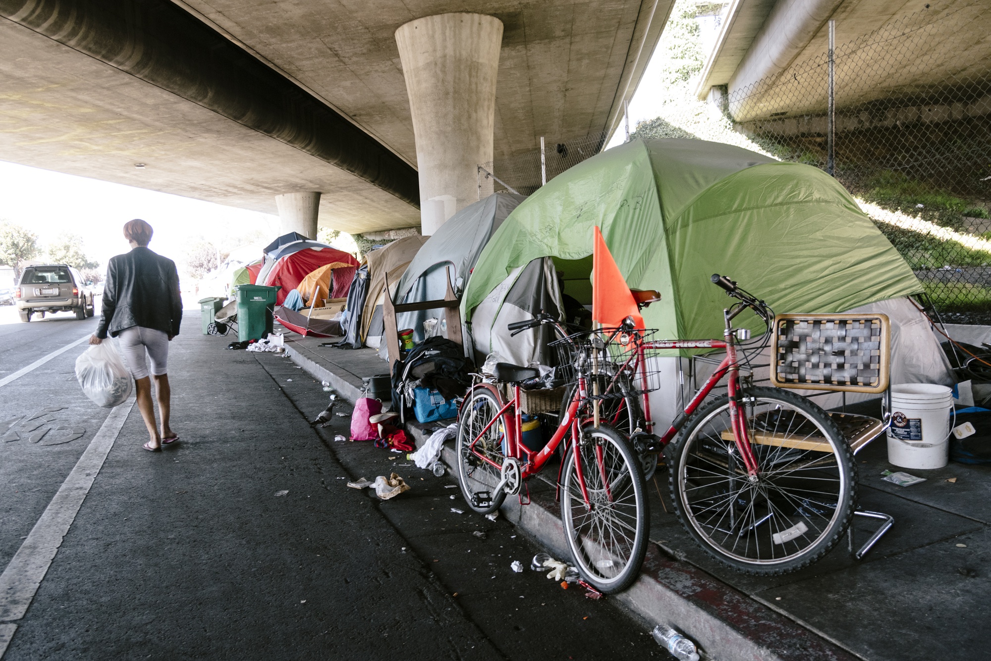 A person walks past a homeless encampment&nbsp;in Oakland, California, on&nbsp;Aug. 30.&nbsp;