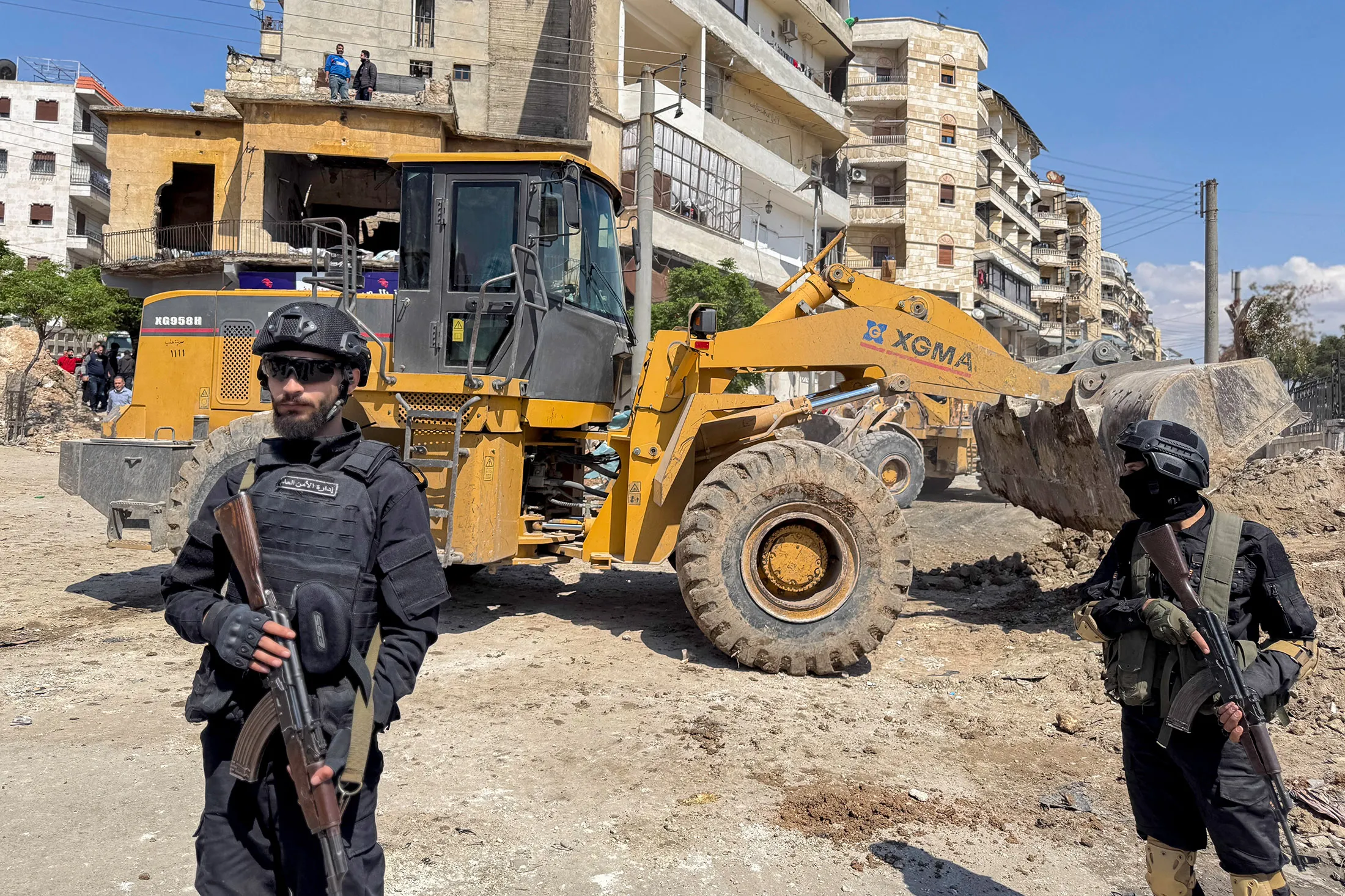 Armed security personnel&nbsp;stand guard near ongoing roadwork in Aleppo, Syria on April 13.