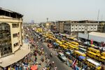 Taxi vans in heavy traffic on Nnamdi Azikwe Street by Idumota market in Lagos, Nigeria.
