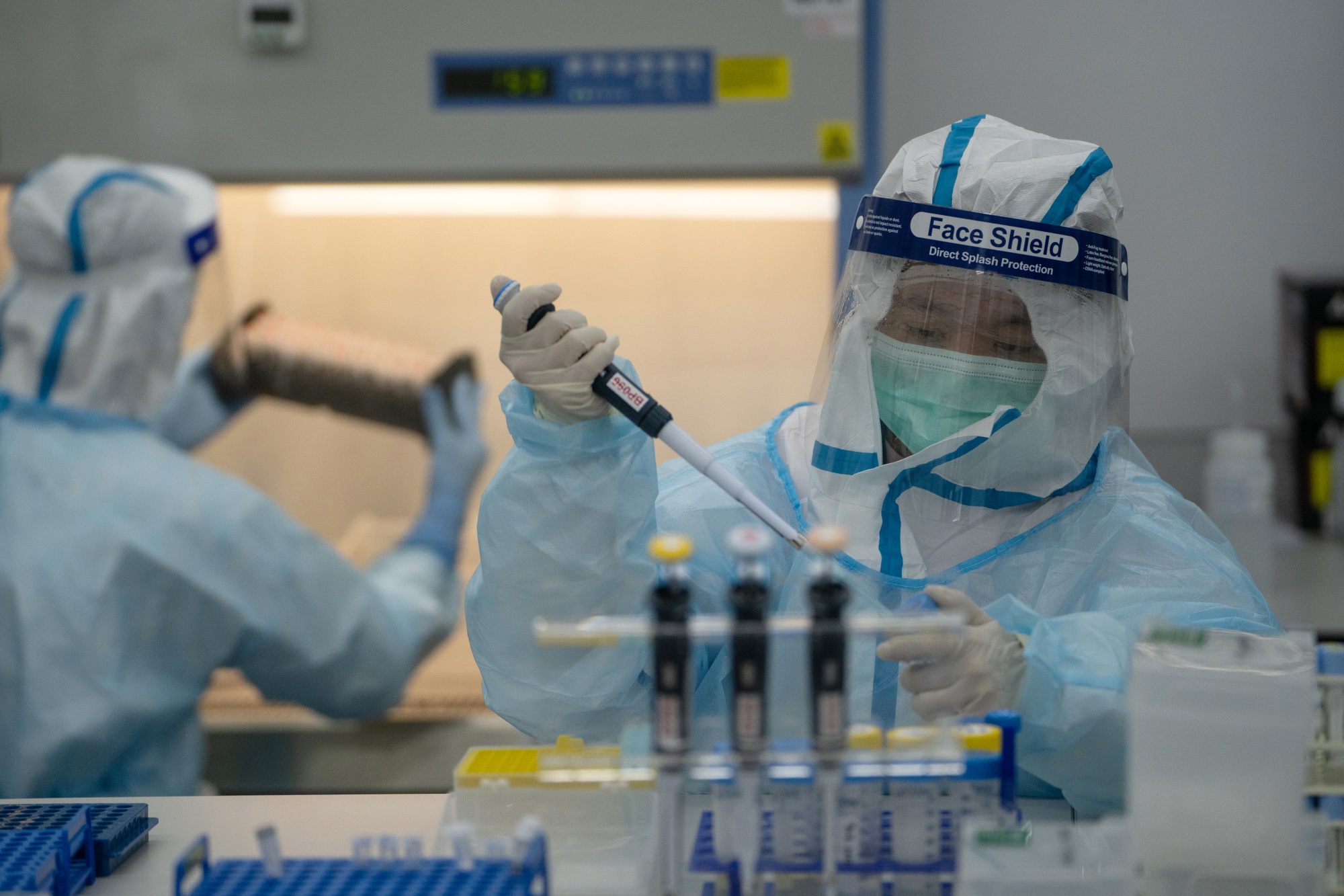 Lab technicians process RT-PCR Covid-19 tests at Prenetics’s laboratory in Hong Kong.