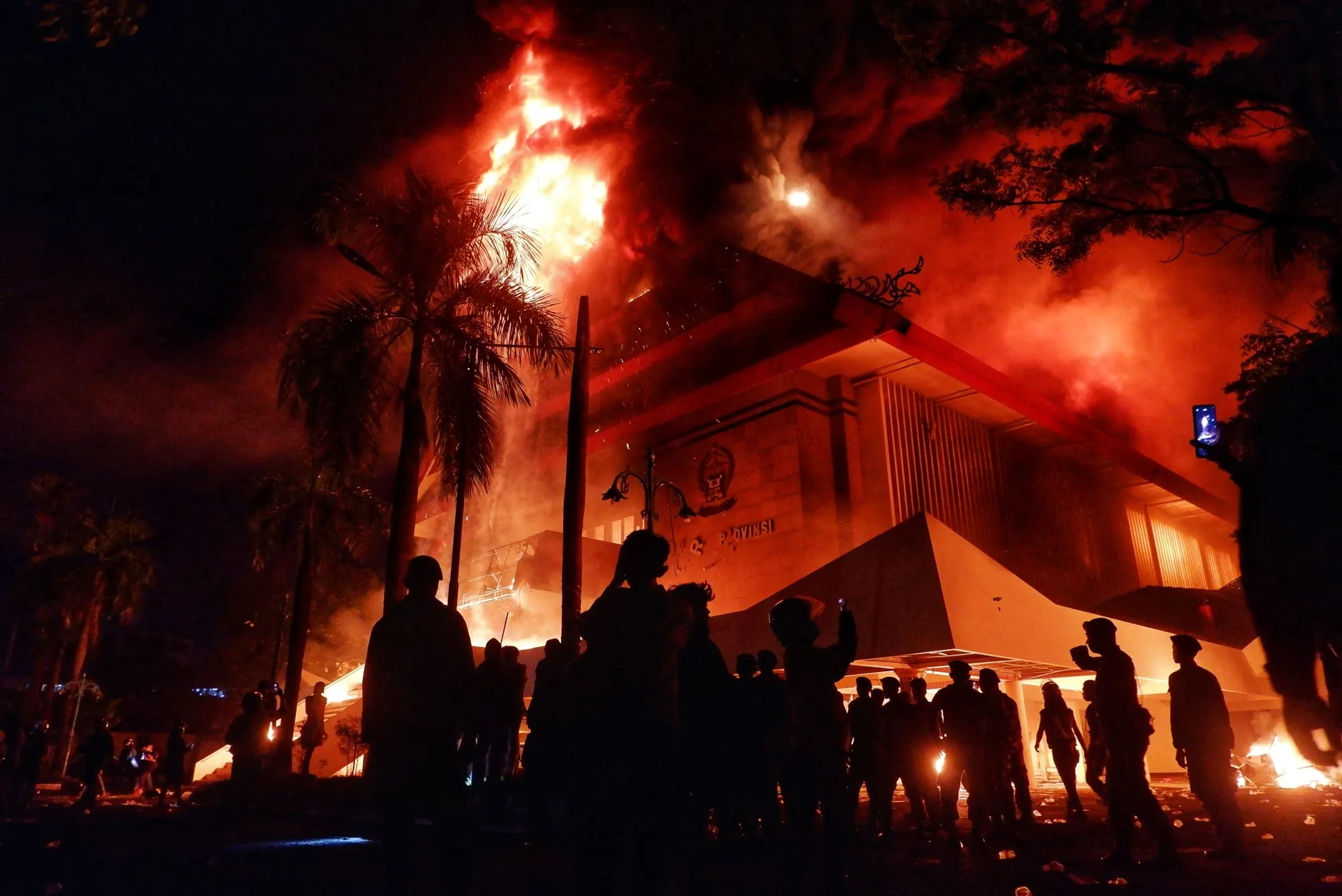 The regional parliament building burns after protesters set it on fire in Makassar, Indonesia on Aug. 29.