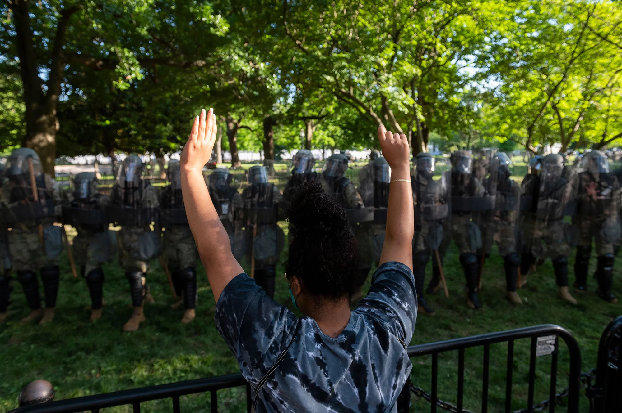 A demonstrator raises her hands near a line of National Guard soldiers deployed near the White House on June 1.