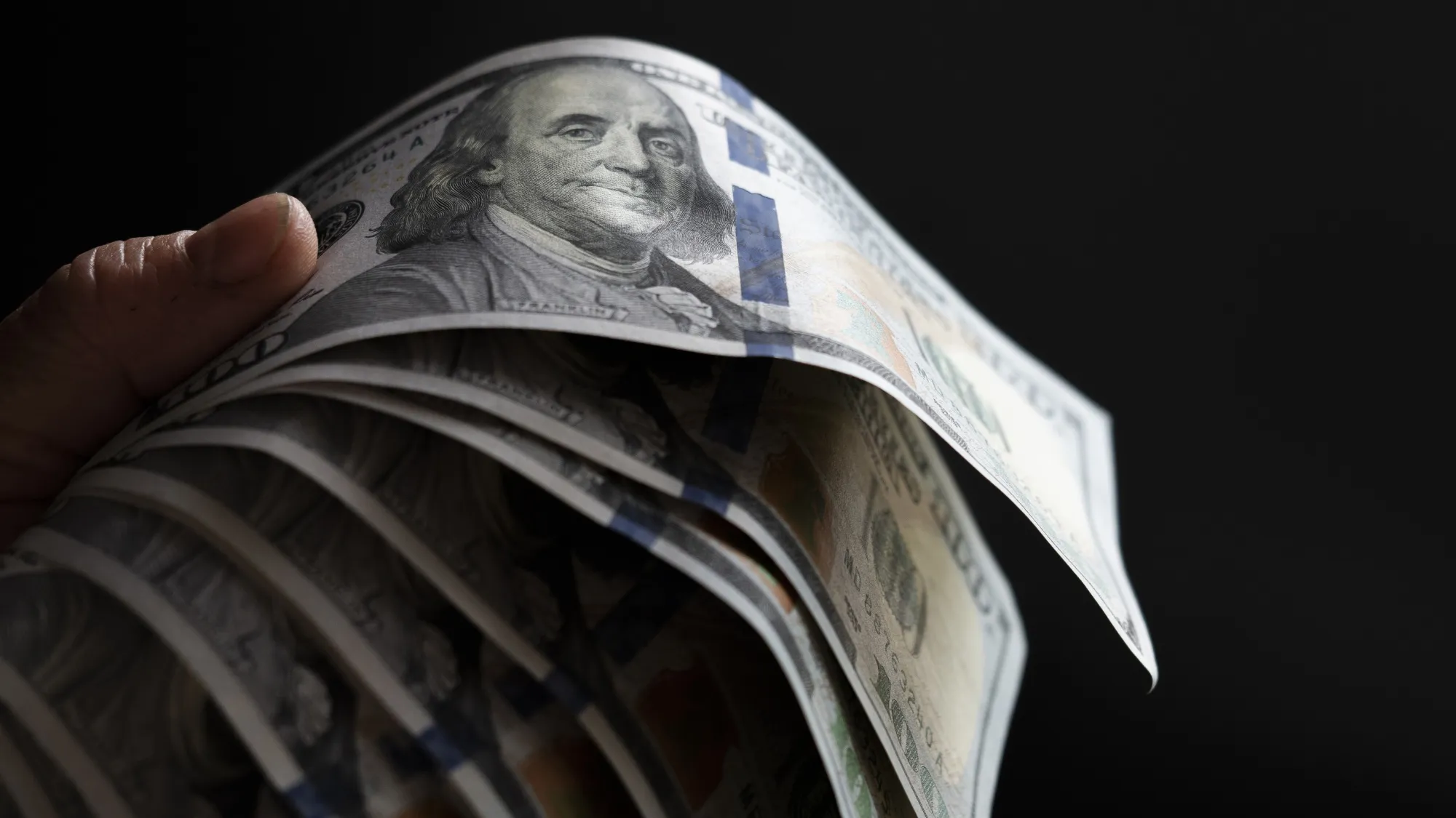 SOCIAL ____ A photo illustration of US 100 dollar bills