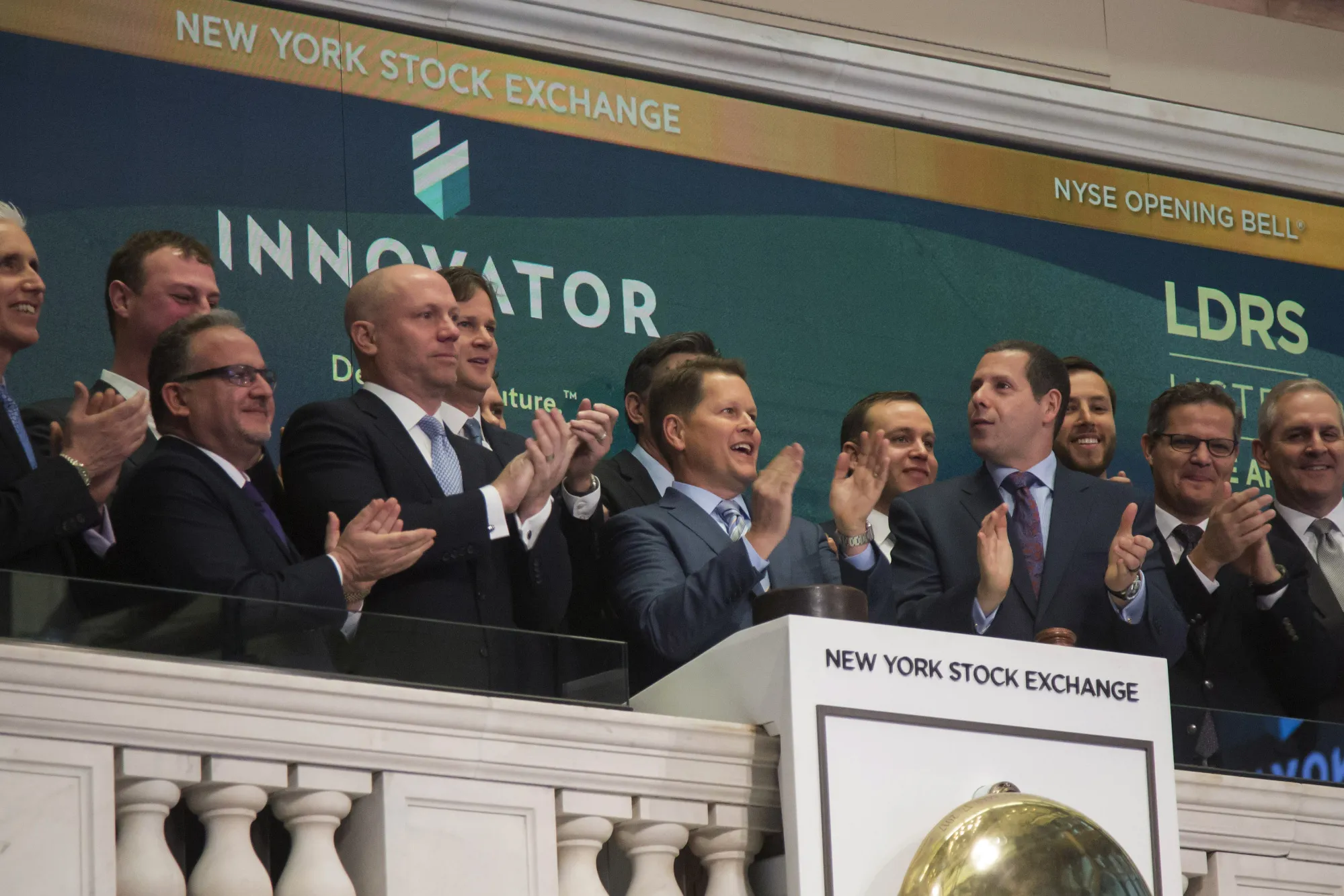 Bruce Bond of Innovator Capital Management, center, rings the opening bell on the floor of the New York Stock Exchange (NYSE) in New York in 2018.
