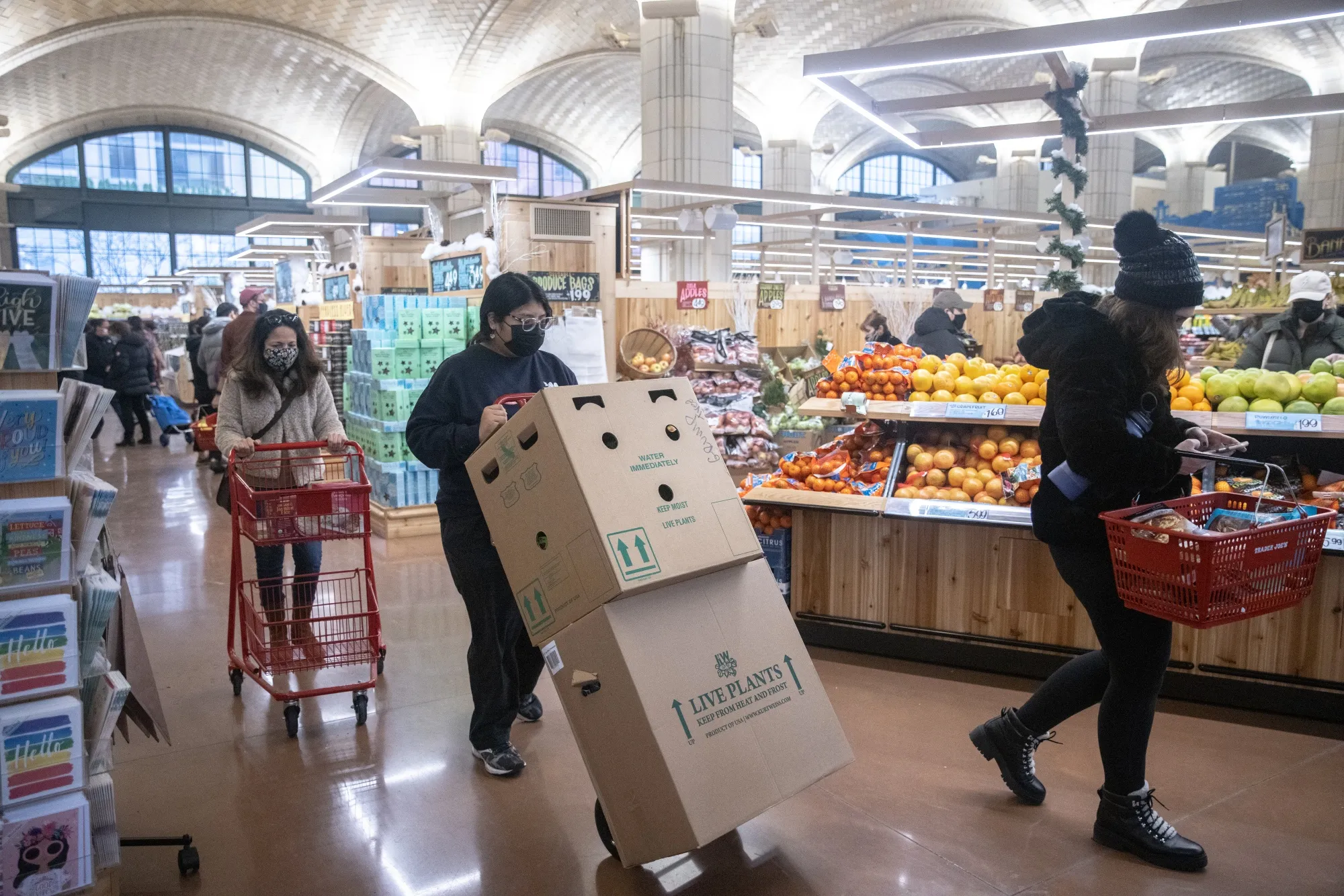 An employee pushes a cart at a grocery store in New York.&nbsp;