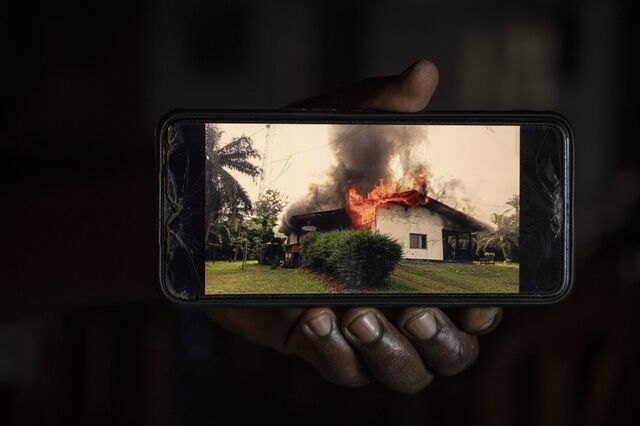 A photo on a phone showing when workers at the Salala plantation set fire to the manager's house in June 2024 during a strike over squalid housing and onerous production quotas.