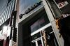 Pedestrians pass in front of a T-Mobile US Inc. store in New York, U.S. on Monday, April 30, 2018. Sprint Corp. suffered its worst stock decline in almost six months, rocked by fears that a proposed $26.5 billion takeover by T-Mobile US Inc. will get rejected by antitrust enforcers.