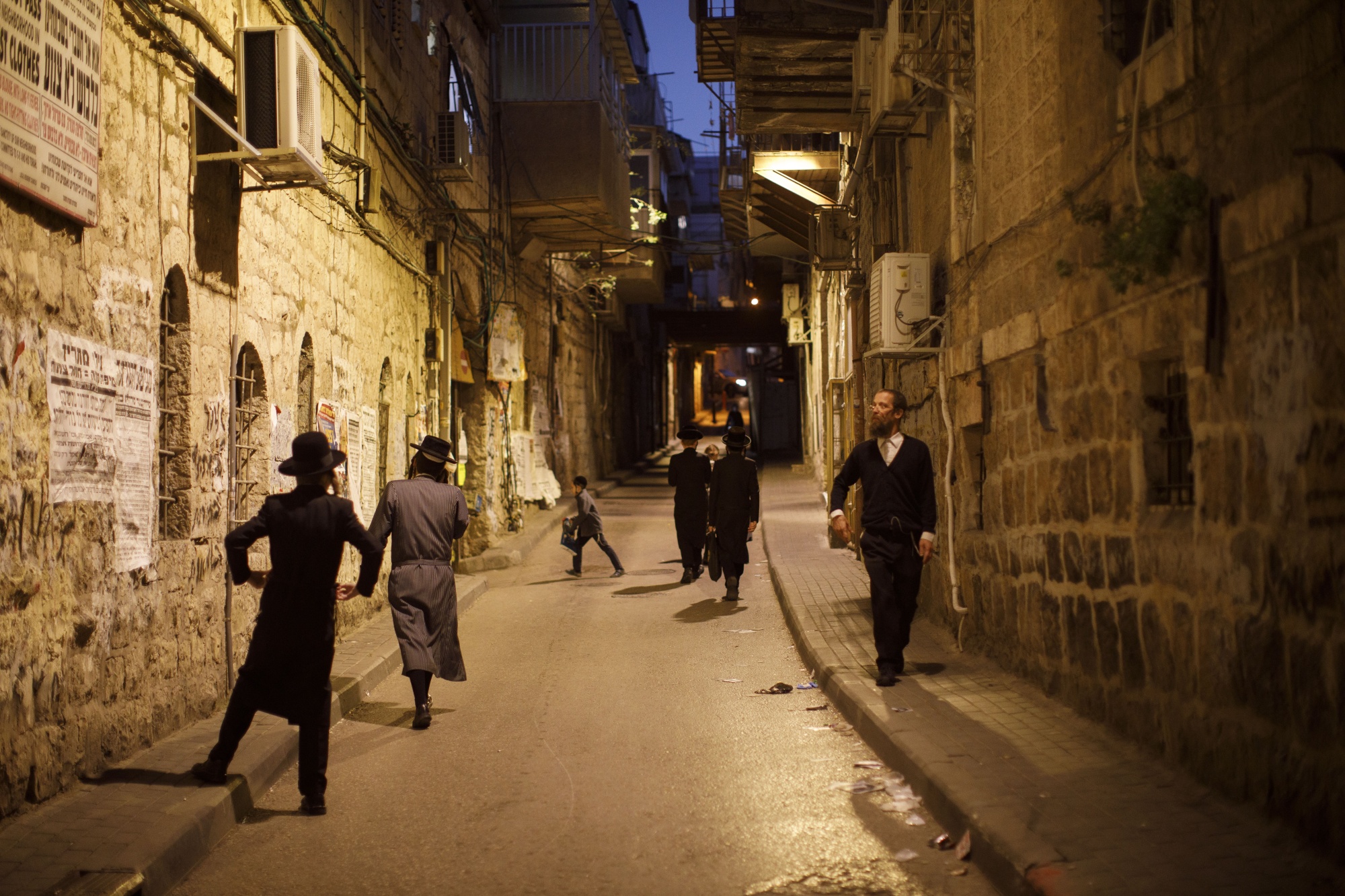 People walk through the Jewish Orthodox neighborhood of Mea She'arim in Jerusalem, Israel March 29.