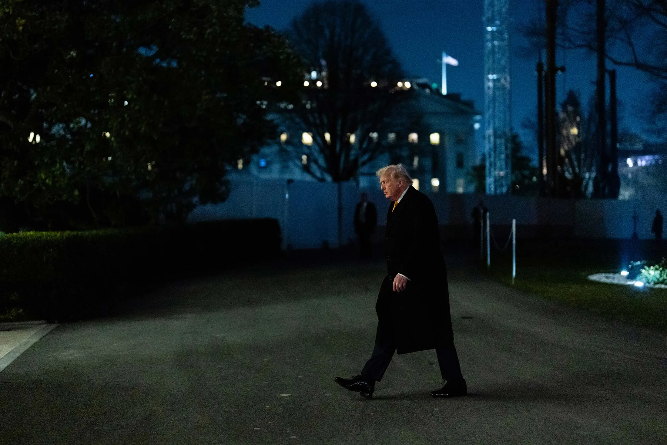 Trump outside the White House after dark.
